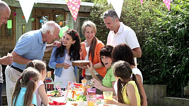 What is decumulation and why should you care? Large family sitting in the garden eating together